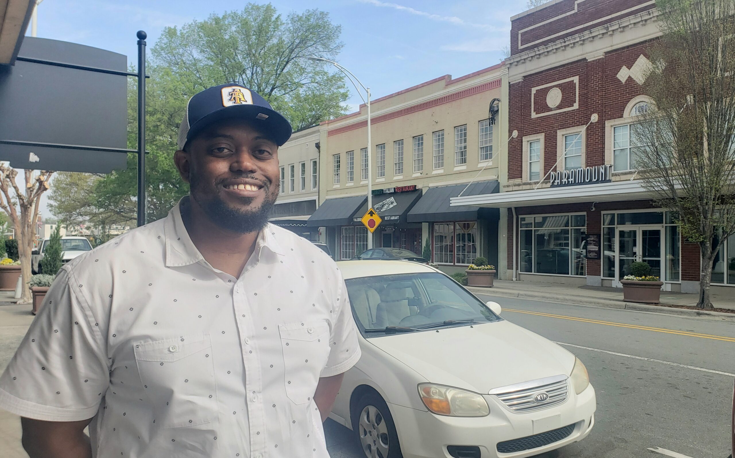 Photo of Seneca Rogers, candidate for Alamance County School Board, with the campaign slogan "We are the neighborhood!" Seneca Rogers is passionate about advocating for inclusive education and community involvement in the school system.