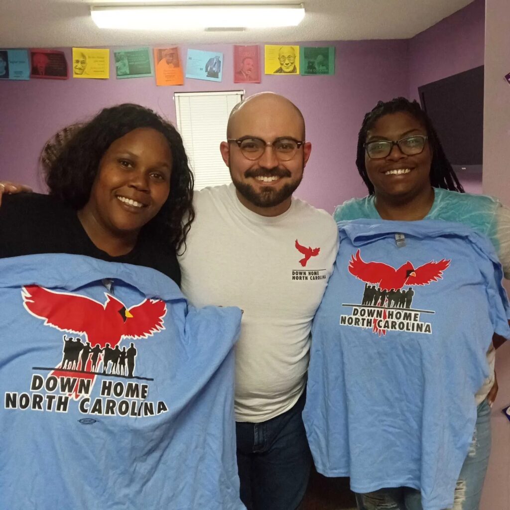 Three members from the Pitt County chapter proudly displaying their Down Home t-shirts, showcasing diversity