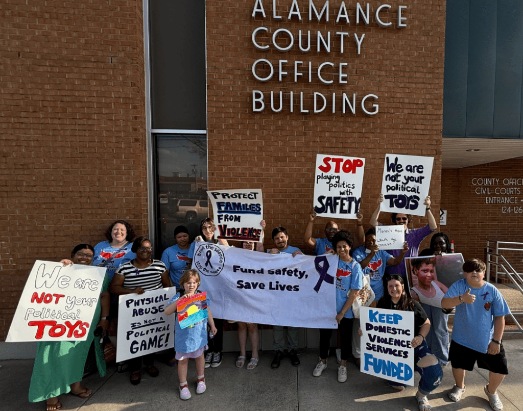 Down Home Members in Alamance County rallying before speaking out at the commissioners meeting on behalf of the Family Justice Center.